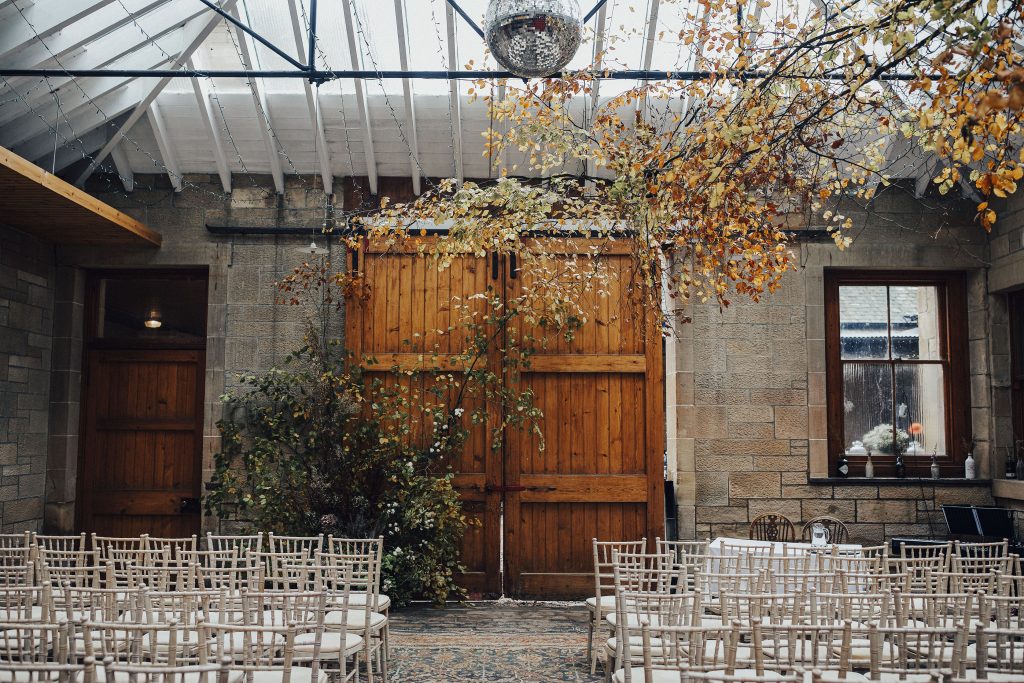 Autumn wedding ceremony with burnt orange trees and natural light